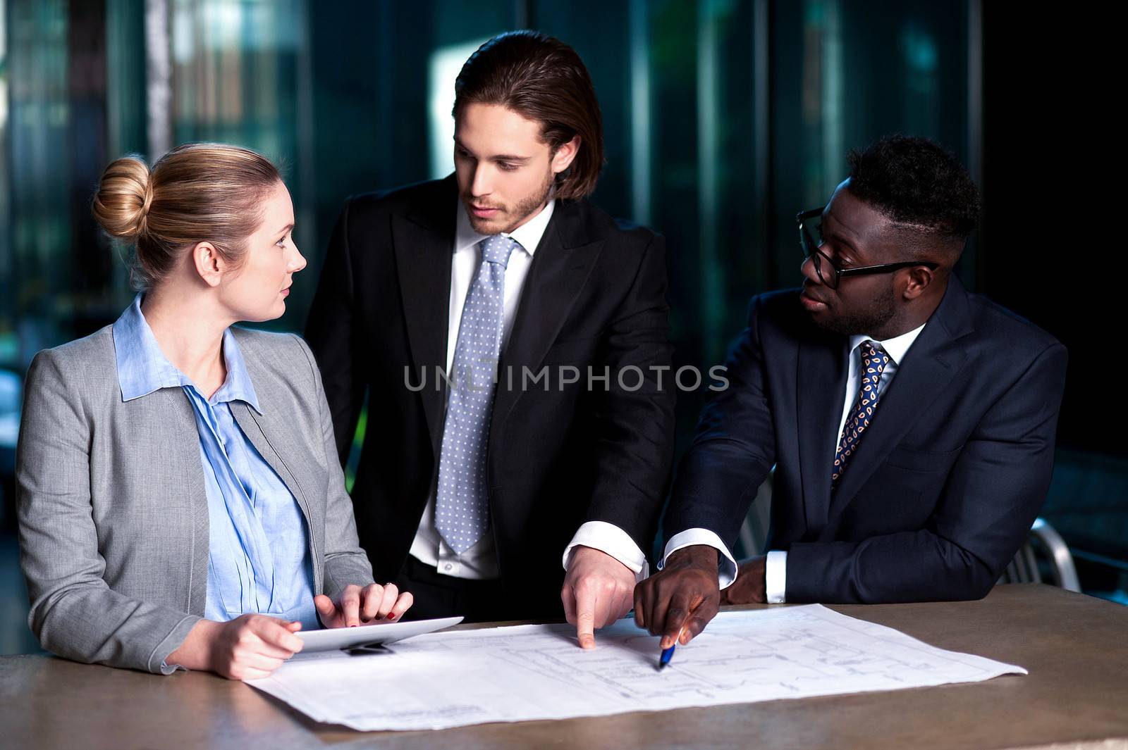 Employer explaining business plan to his colleagues by stockyimages