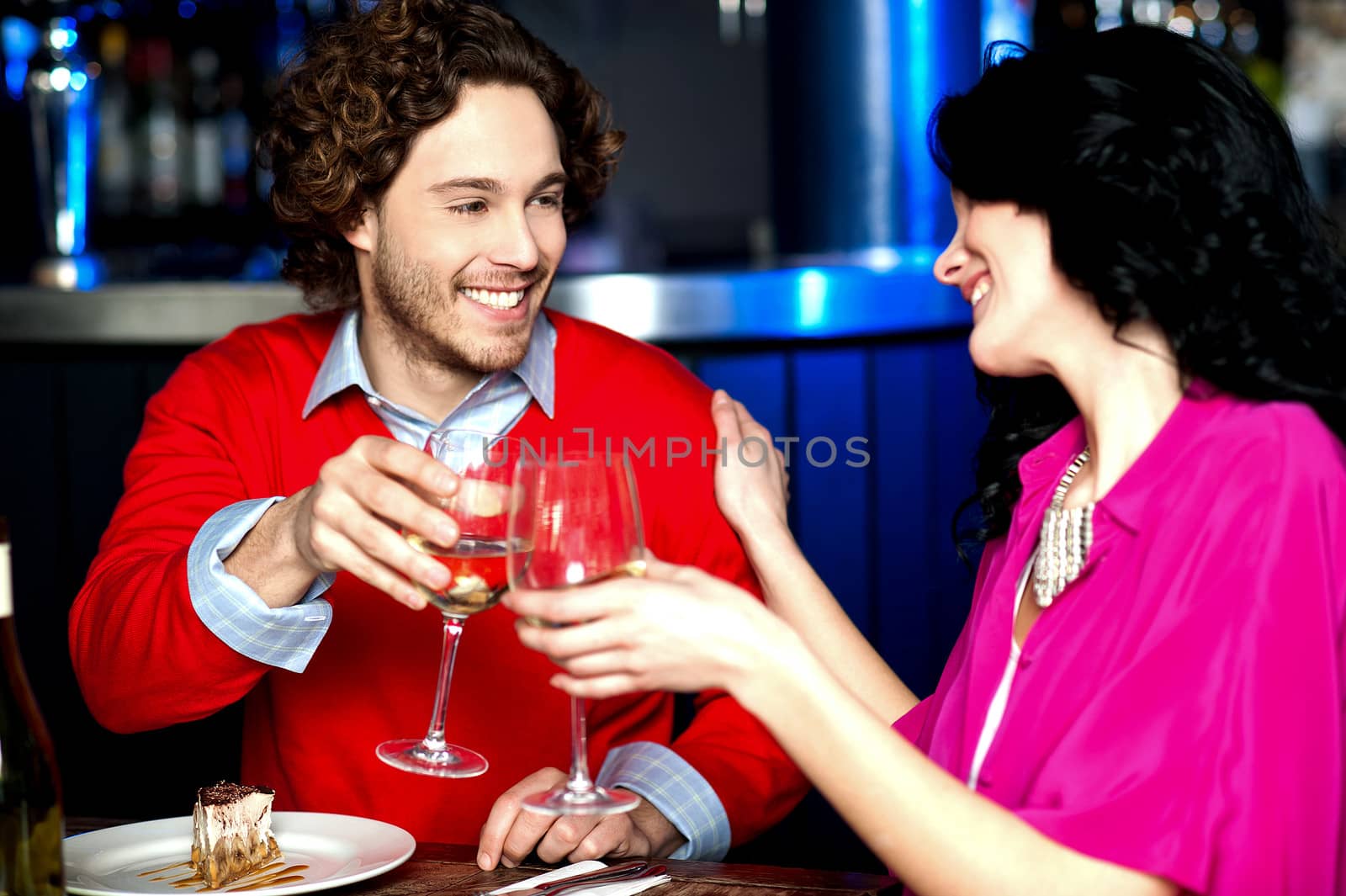Cheers! Couple celebrating their love together by stockyimages