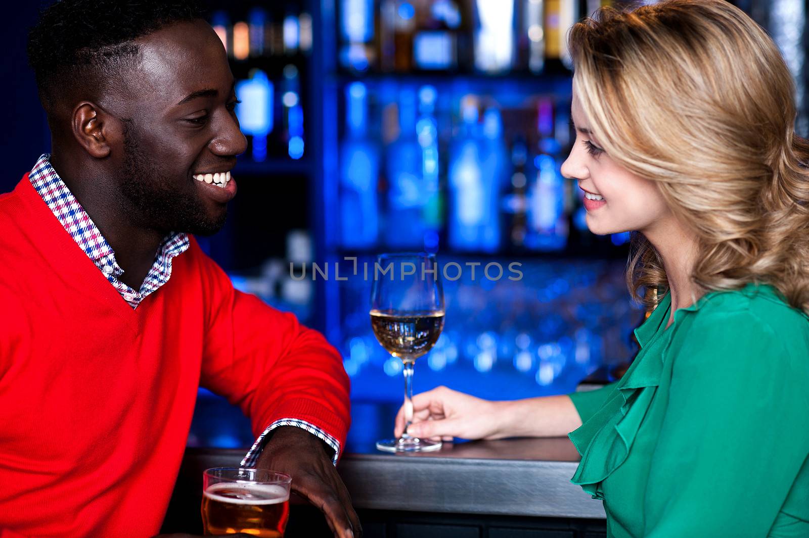 Young romantic couple enjoying cocktails in nightclub.
