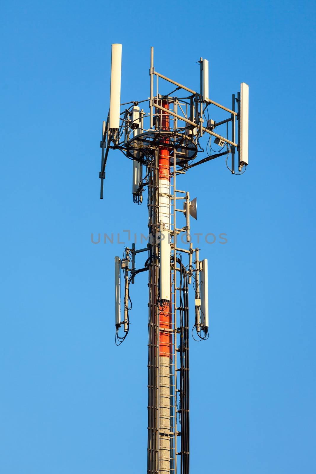 Cellular communication tower on blue sky background