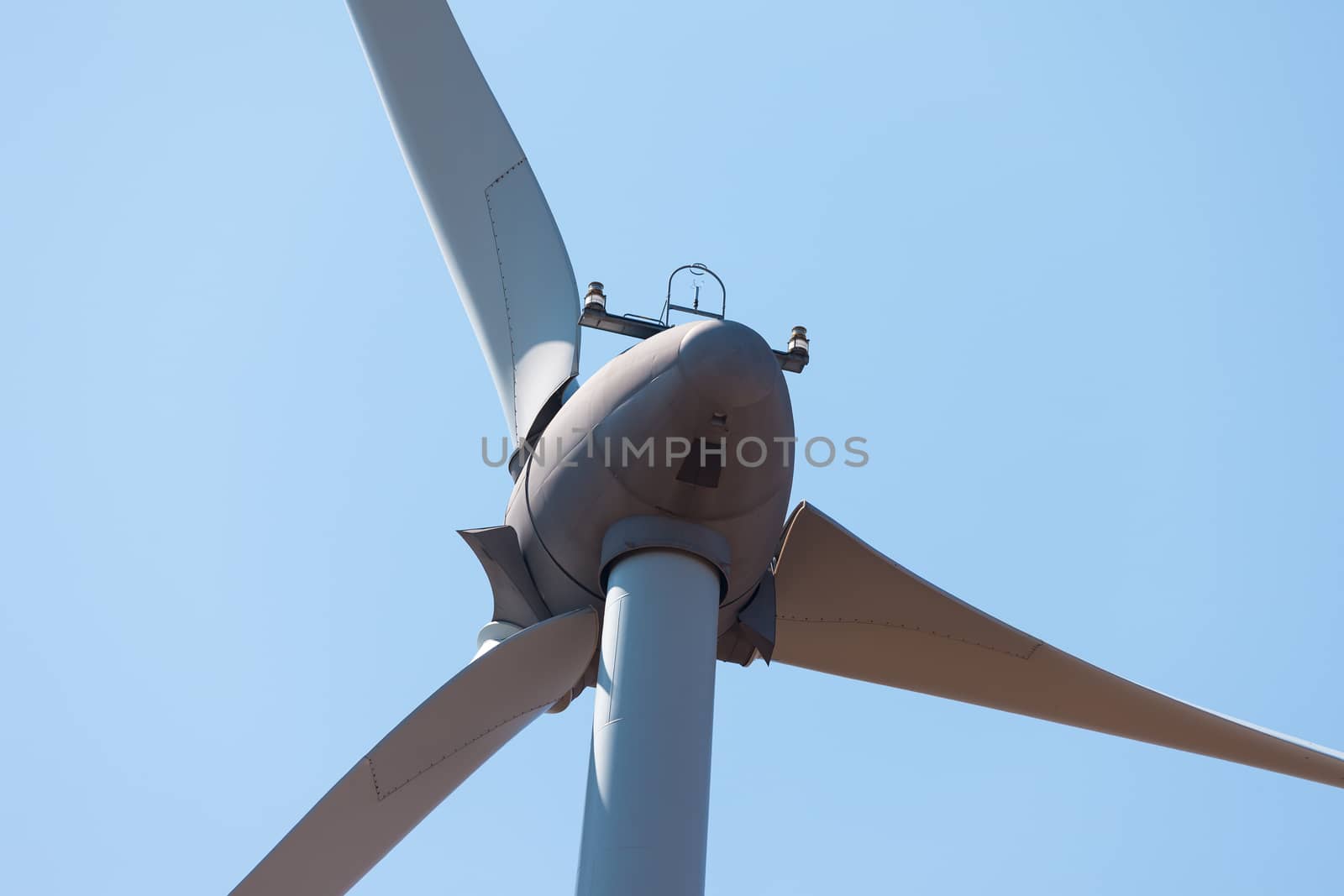 Wind electric generator against blue sky background, closeup