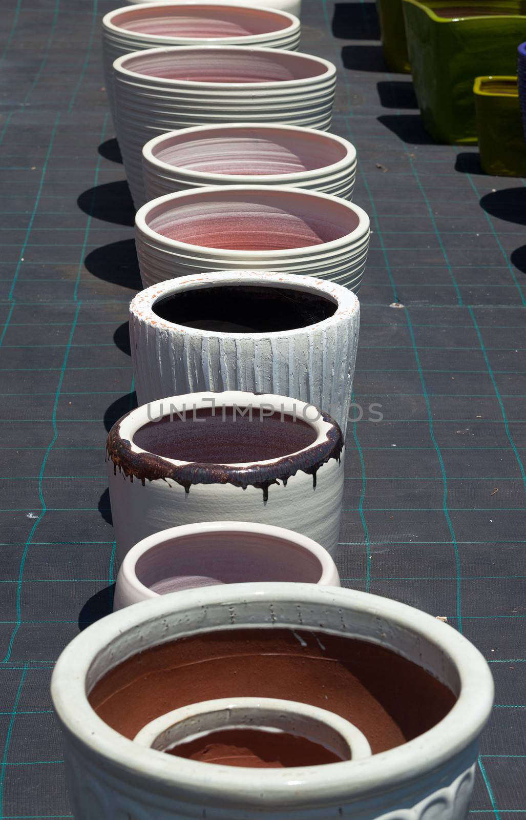 Colorful ceramic pots in market, sunny day