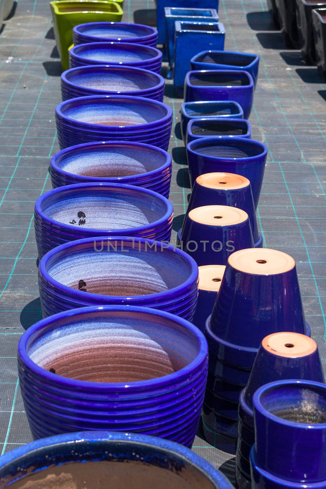 Colorful ceramic pots in market, sunny day