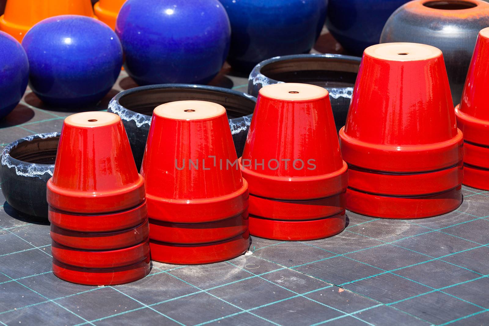 Colorful ceramic pots in market, sunny day