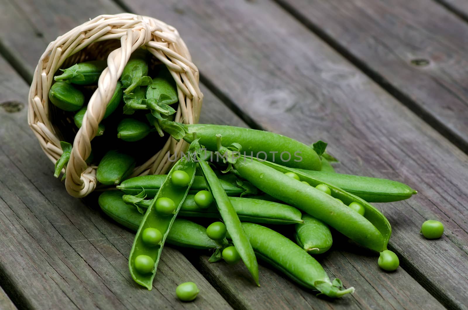 Fresh peas on a background of old boards