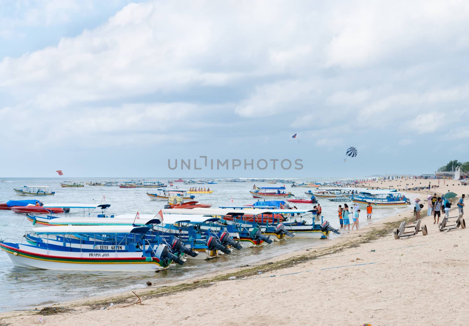 NUSA DUA, BALI - SEP 13: Motor boats on sand beach in Tanjung Benoa area on Sep 13, 2012 in Nusa Dua, Bali. Tanjung Benoa is popular tourist place for  watersport and various games.