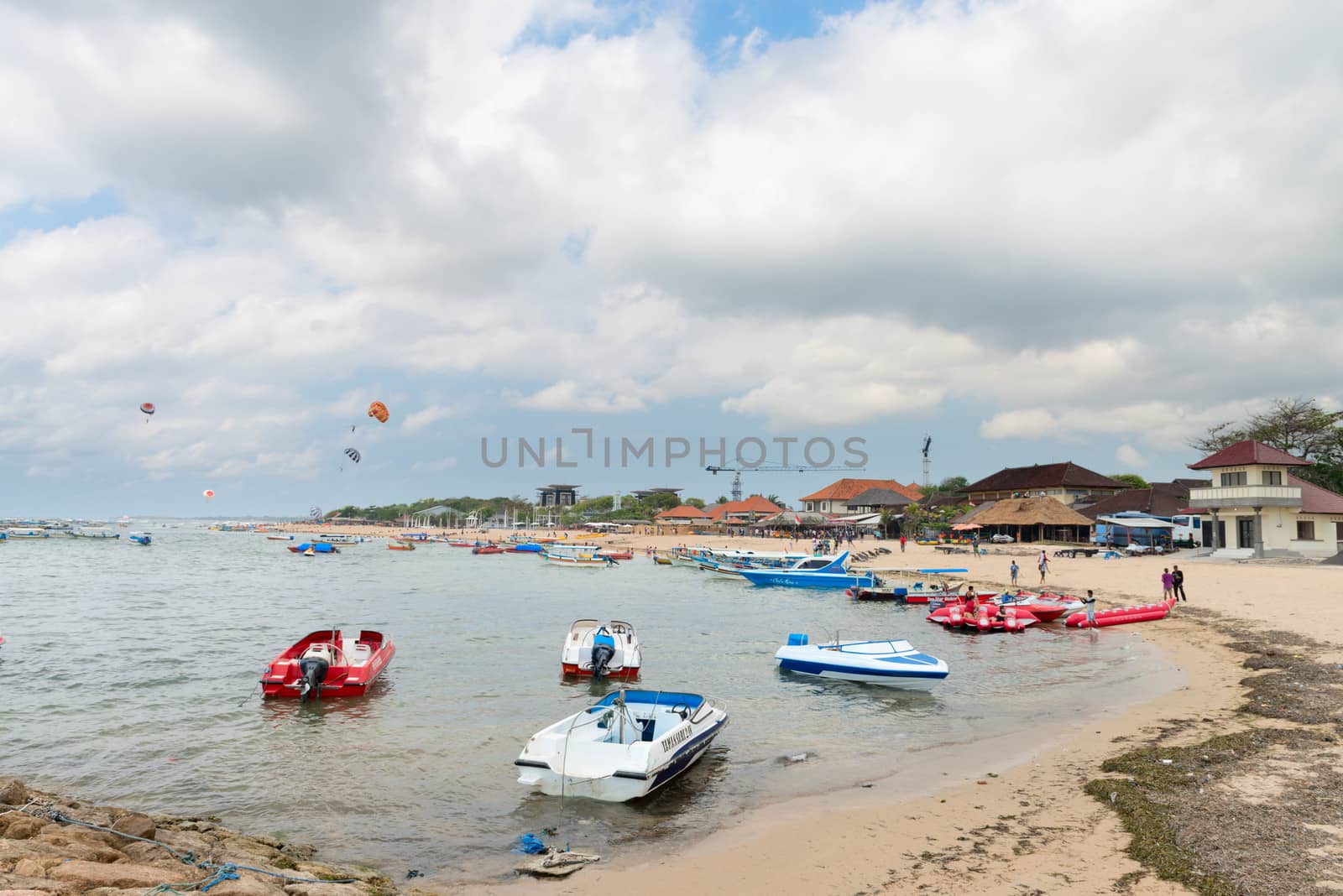 NUSA DUA, BALI - SEP 13: Motor boats on sand beach in Tanjung Benoa area on Sep 13, 2012 in Nusa Dua, Bali. Tanjung Benoa is popular tourist place for  watersport and various games.