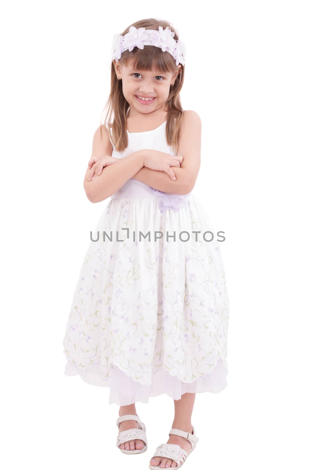 Full length portrait of a little girl standing with folded hands over white background