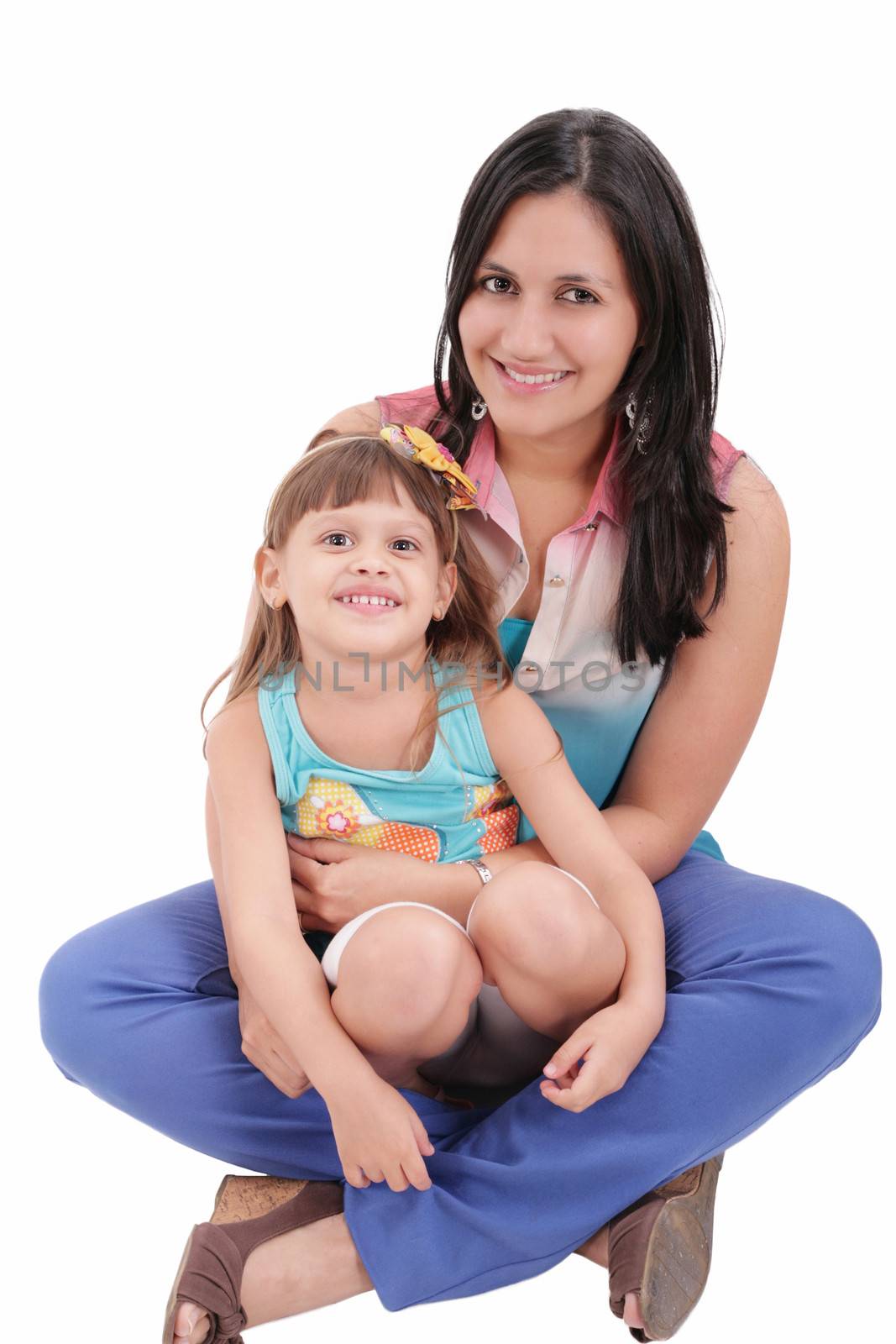 mother and daughter sitting on the floor and hugging each other isolated on white