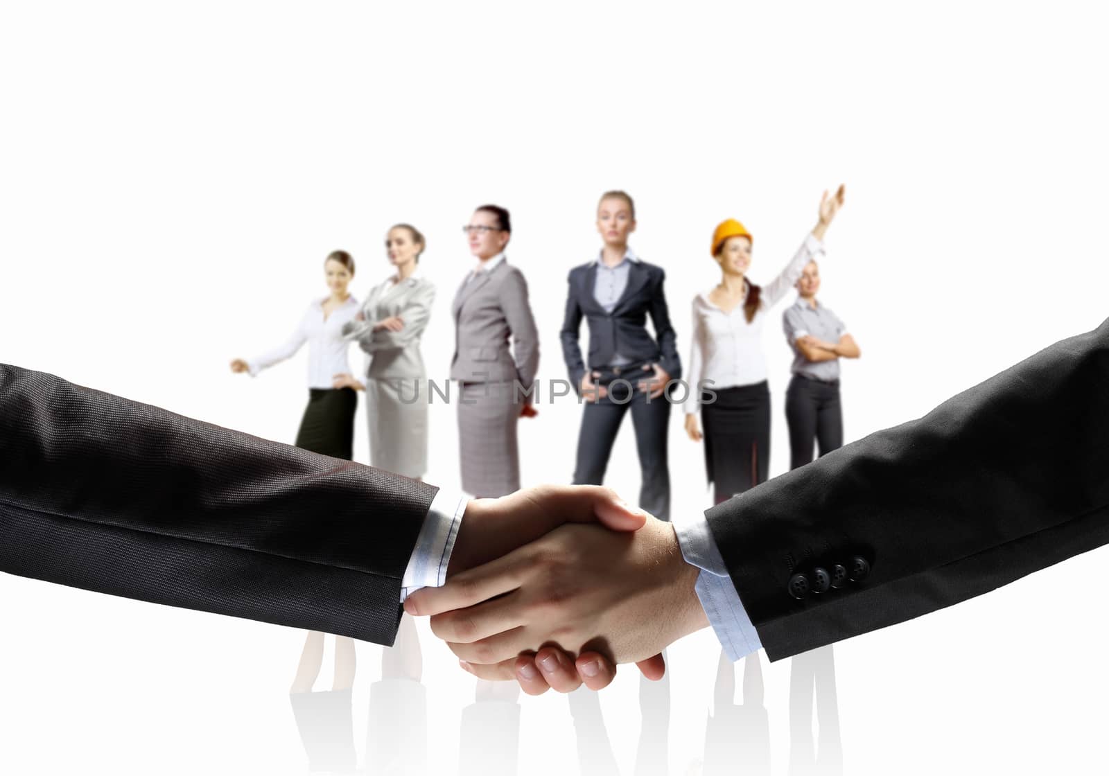 business handshake against white background and standing businesspeople