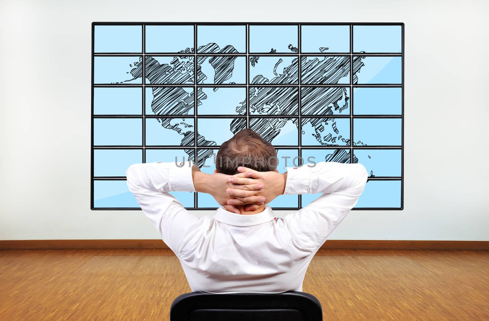 businessman looking at map of world on flat panels