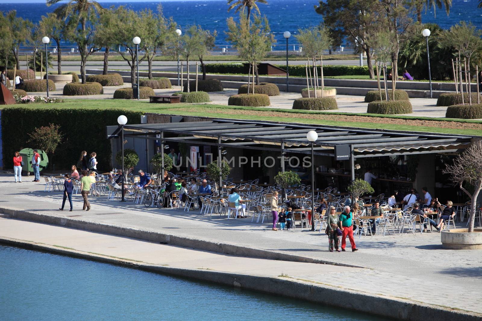 People seated at an open -air restaurant by Farina6000