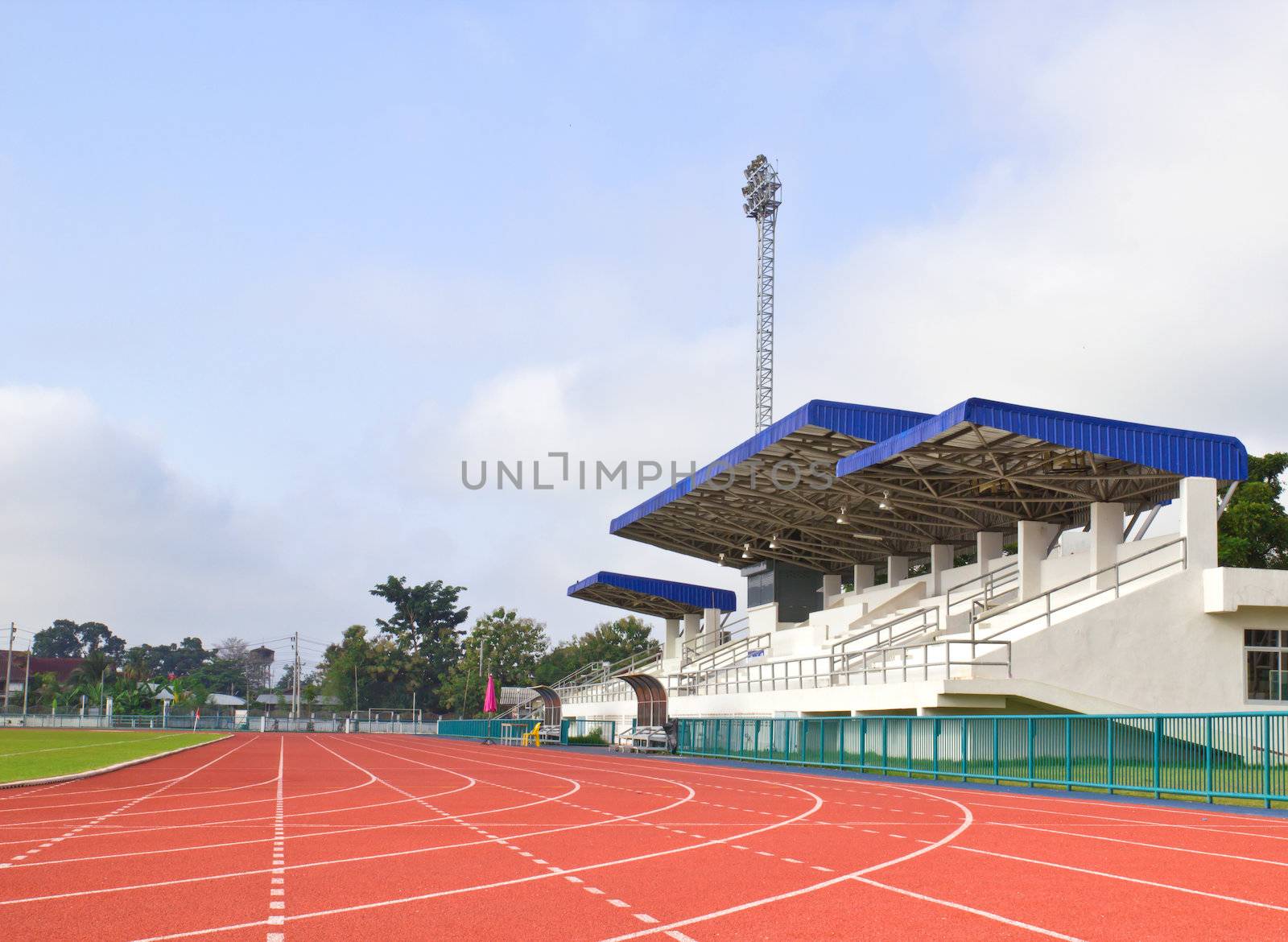 Stadium main stand and running track with blue sky background