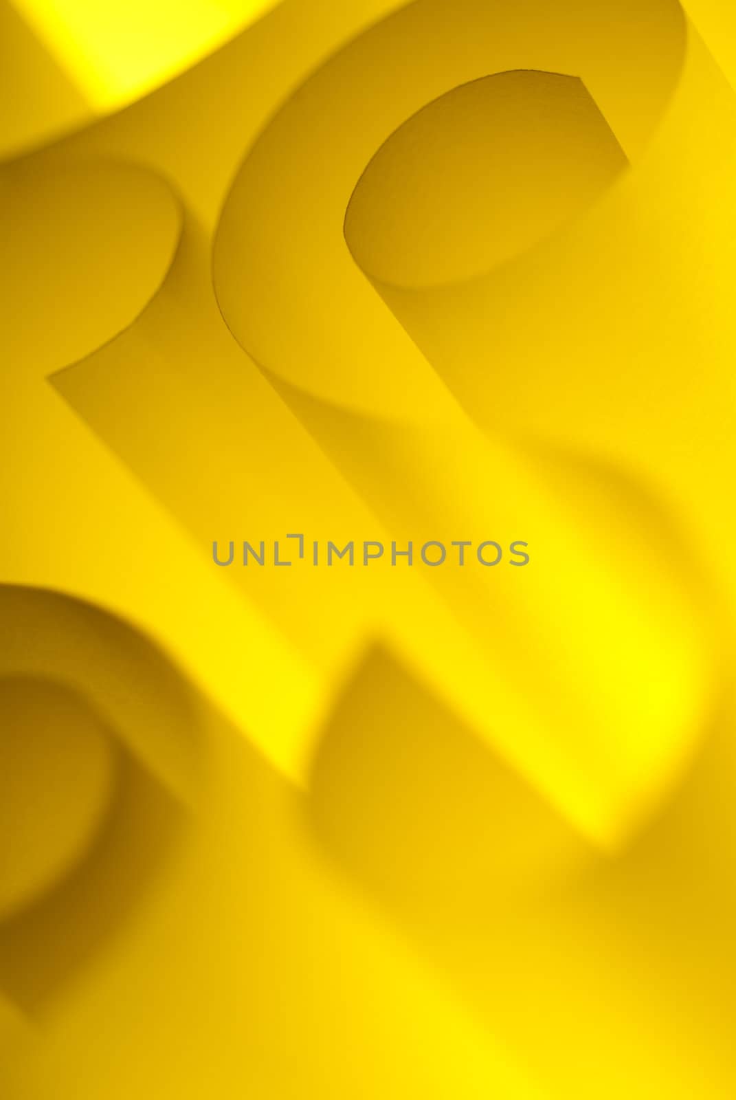 Abstract design paper spirals closeup backlit yellow