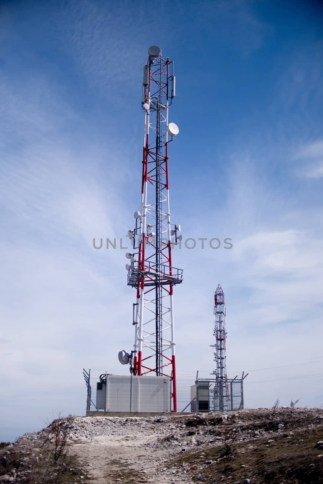 Telecommunications tower seated on top of a hill