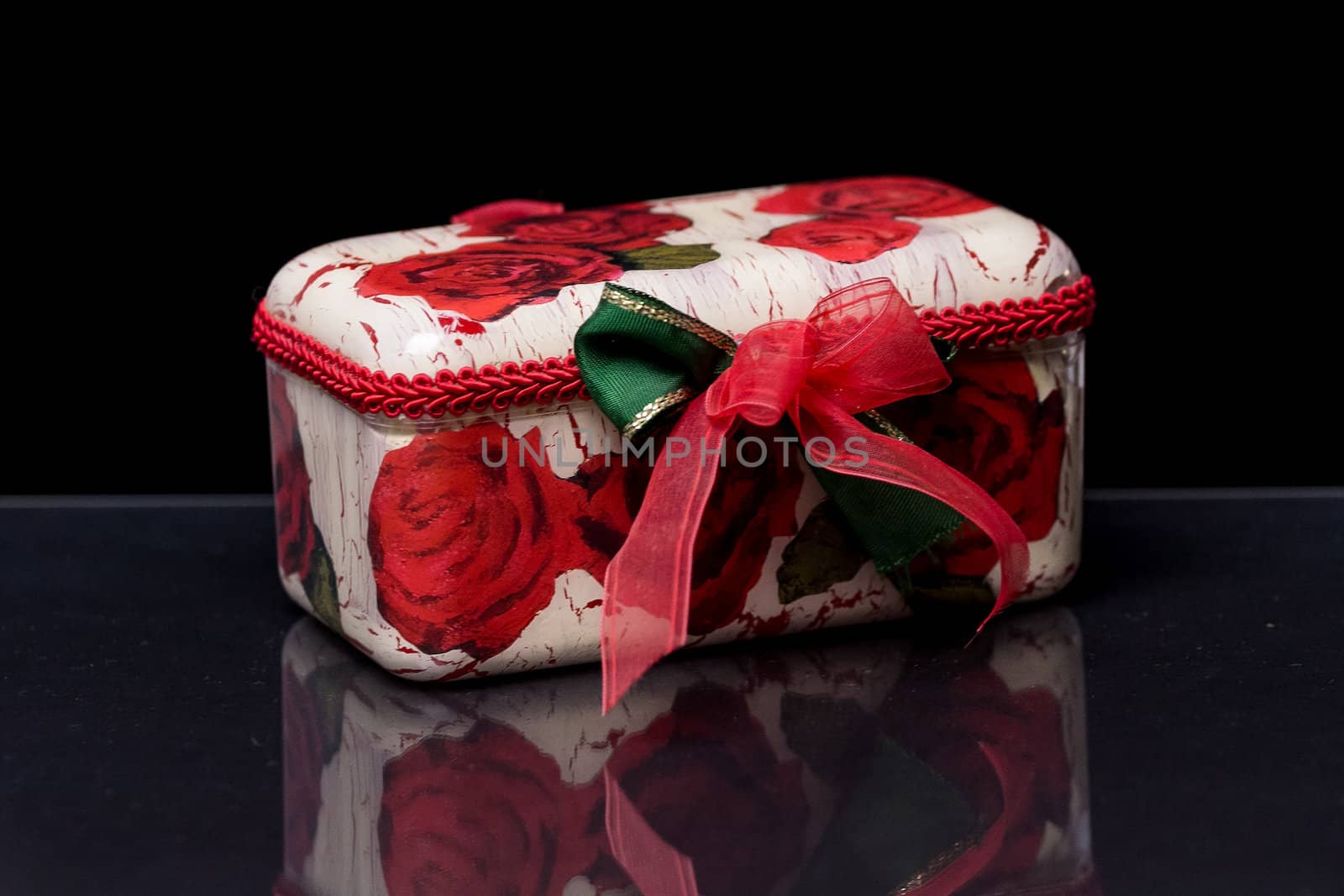 Decorative Decoupage White Rose Box with a red Ribbon







on a reflective black surface with black background