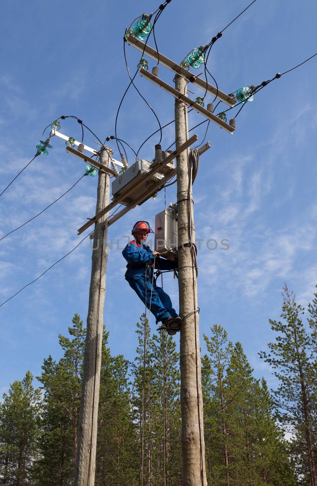 Electrician perform maintenance on the transmission towers reclo by AleksandrN