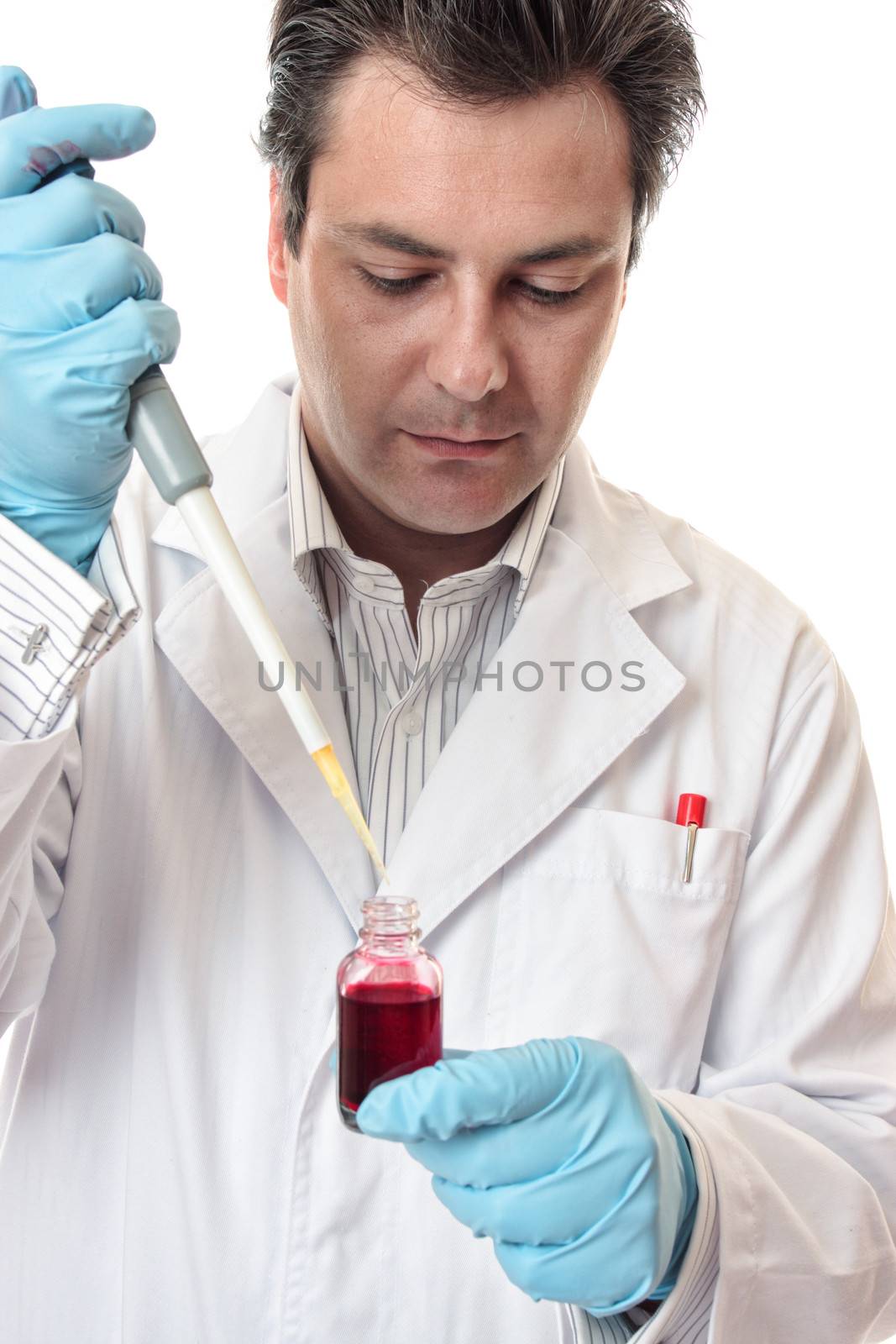 Amale  scientist using a pipette for accuracy.