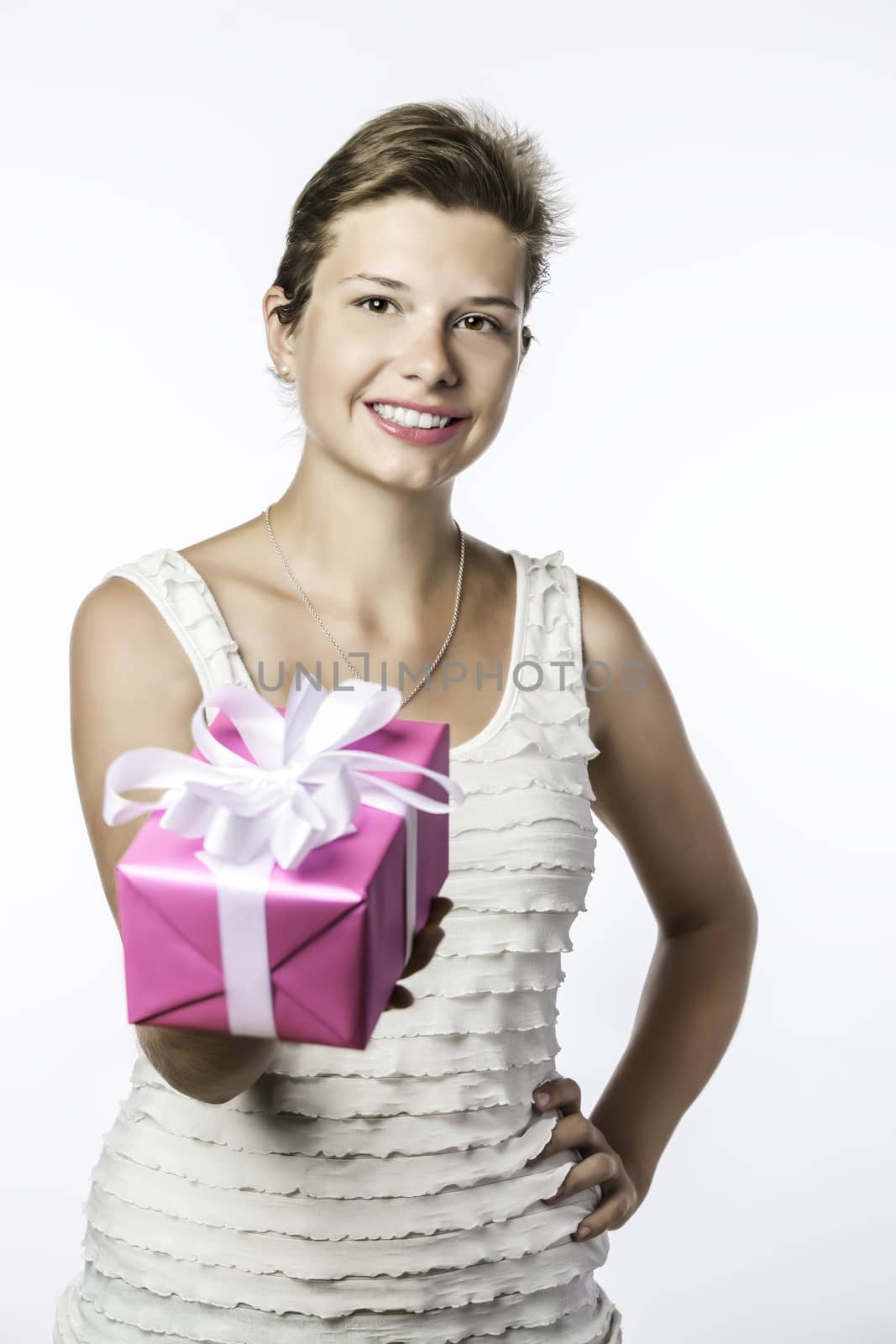 Young brunette girl with birthday, christmas or valentine gift, isolated on white brackground