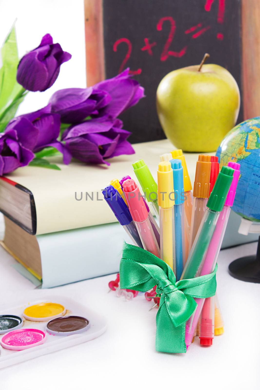 Stationary with flowers and books isolated on white