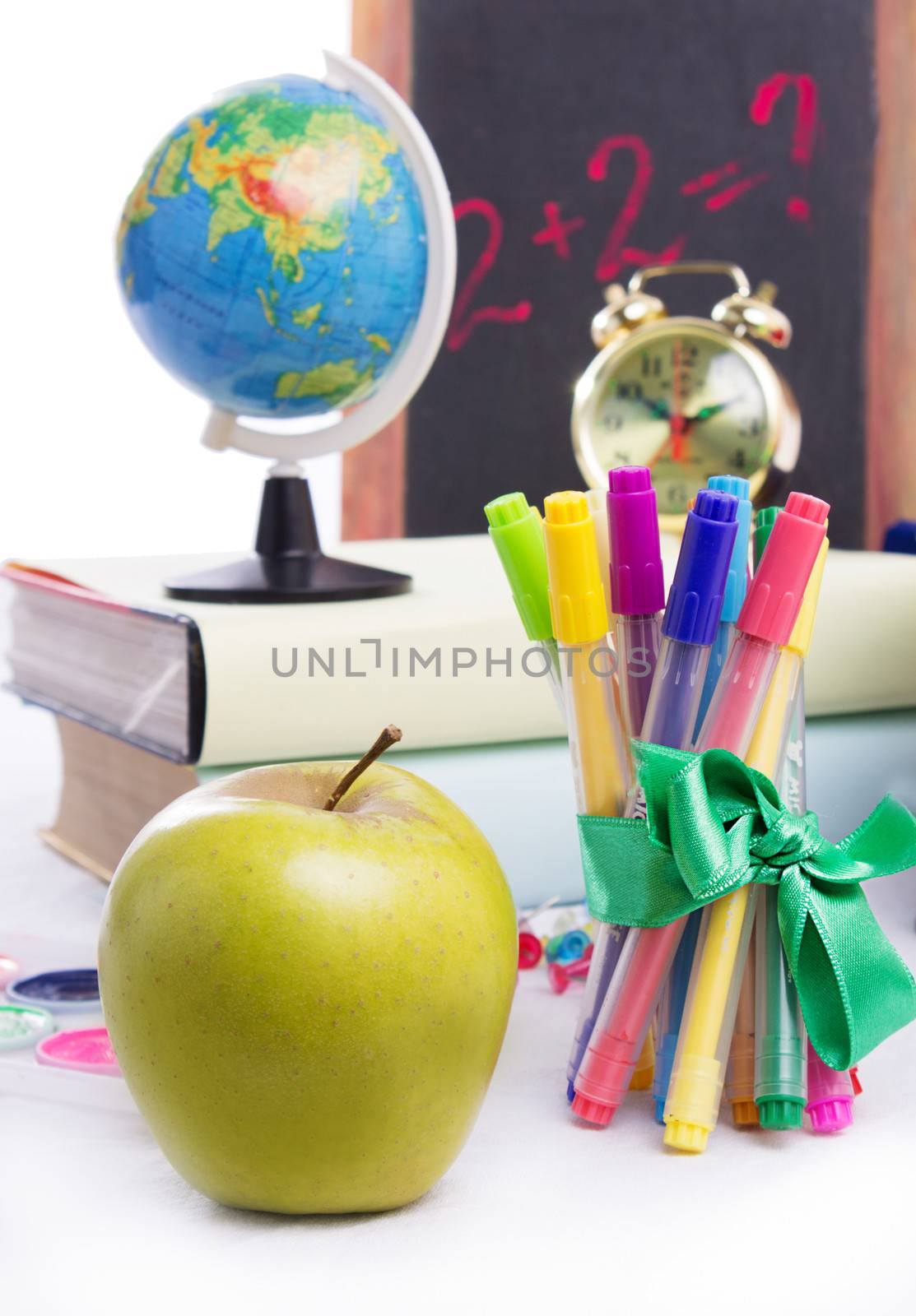 Back to school concept with stationary and apple isolated on white