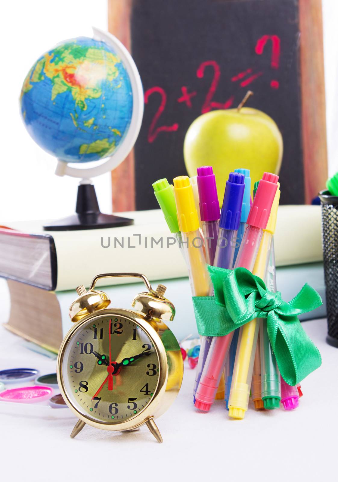 Some school stationary with clock isolated on white