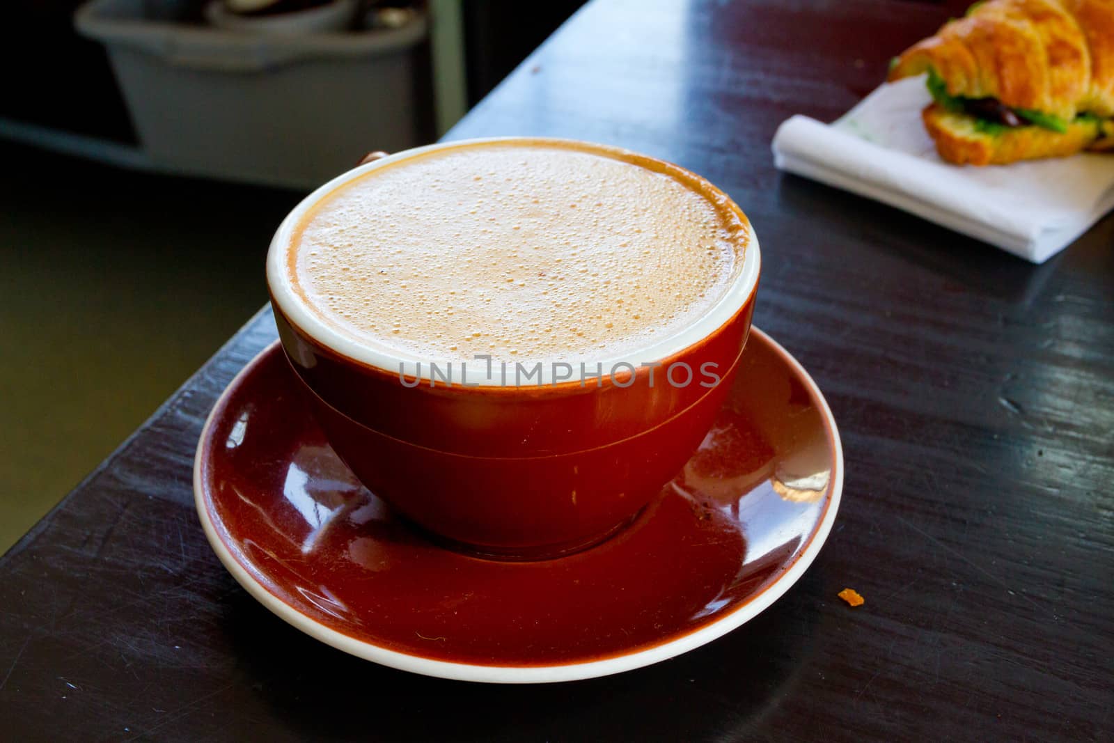 A mocha is served in a ceramic mug at a restaurant that makes amazing coffee and latte.