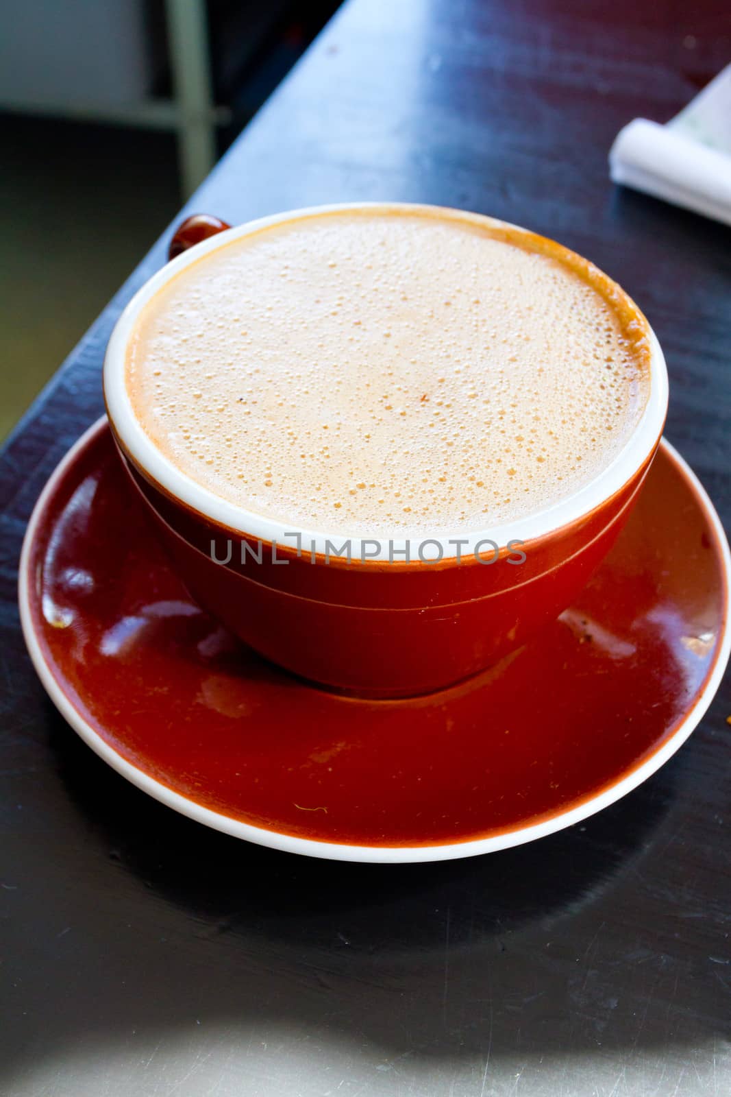 A mocha is served in a ceramic mug at a restaurant that makes amazing coffee and latte.