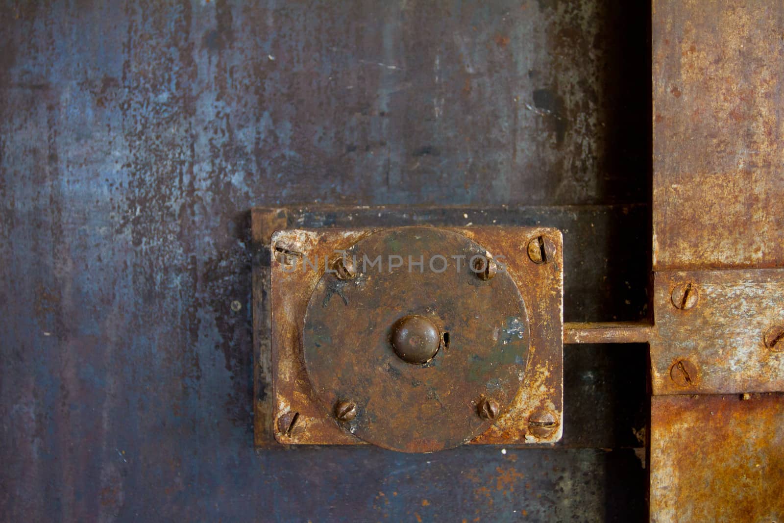 A door handle lock detail on an old building in the doorway to a restaurant.