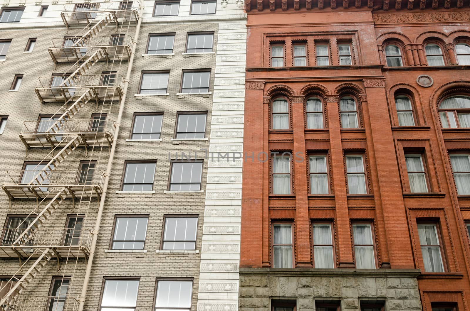 The facades of two different old different color brick buildings in downtown Portland, Oregon