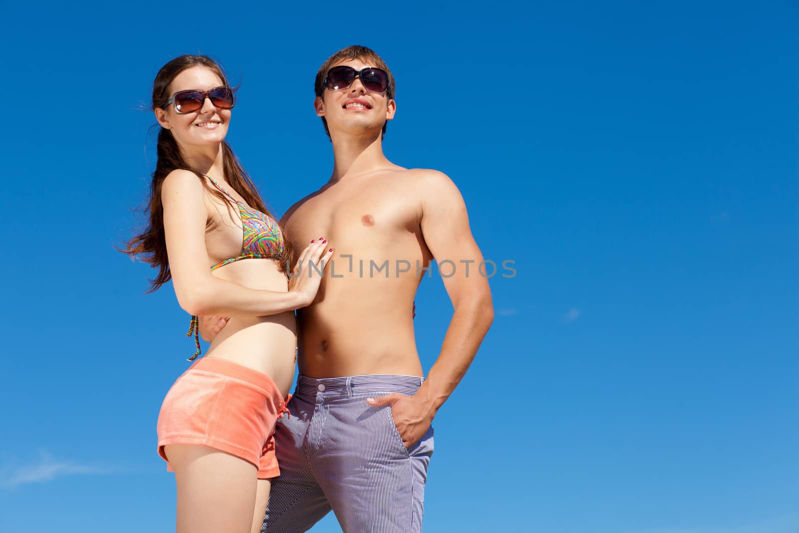 Happy Young Couple Together On The Beach by sergey_nivens