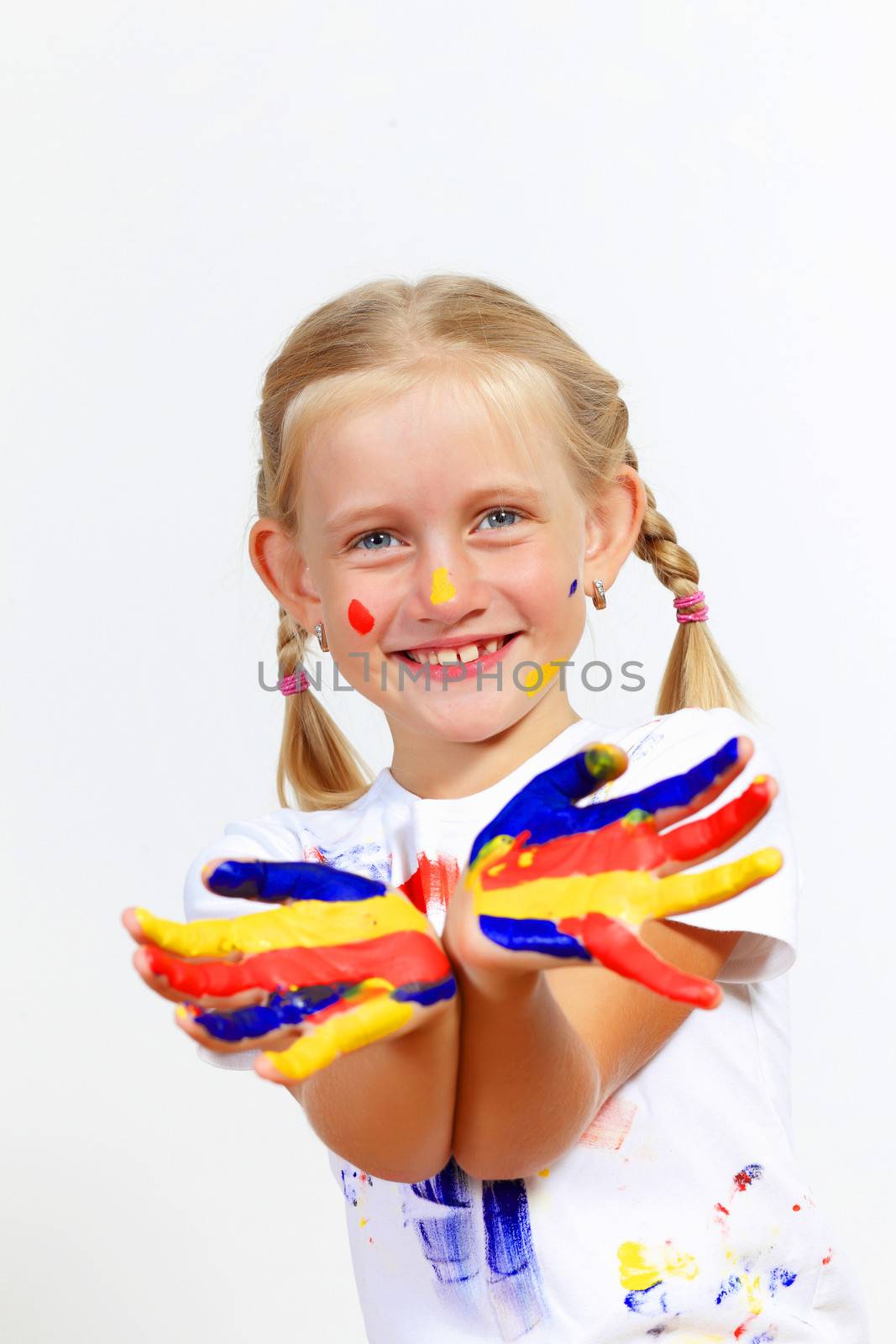 little child with hands painted in colorful paints ready for hand prints