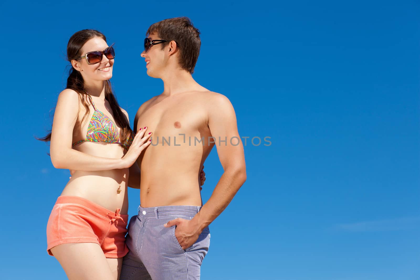 Portrait of a happy young couple enjoying at beach