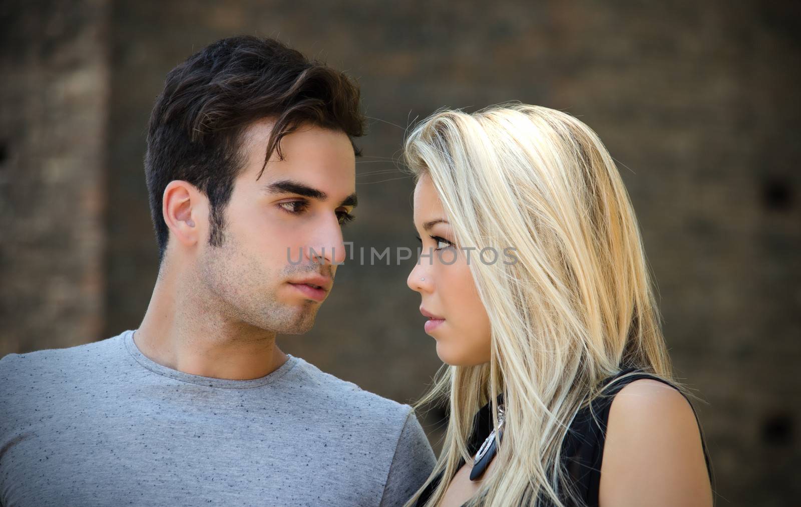 Attractive couple in love looking into each other's eyes by artofphoto
