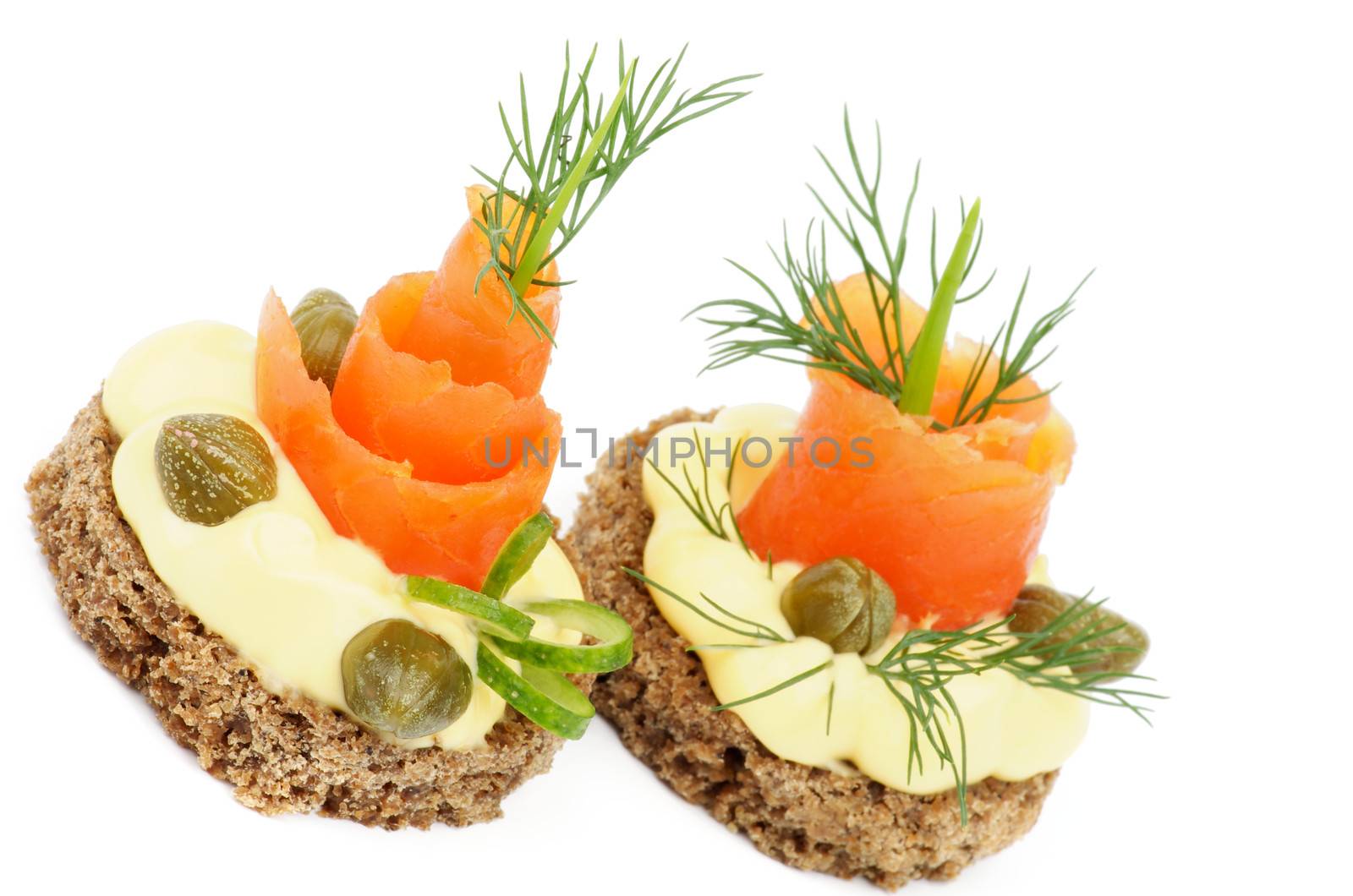 Snacks with Smoked Salmon, Greens, Cheese Cream and Capers isolated on white background