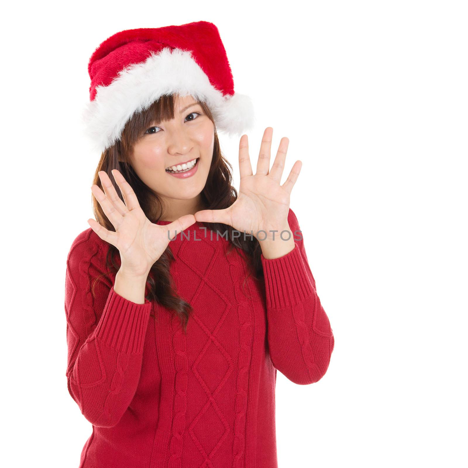 Happy Christmas woman excited say hello isolated on white background wearing red Santa hat. Beautiful Asian model.