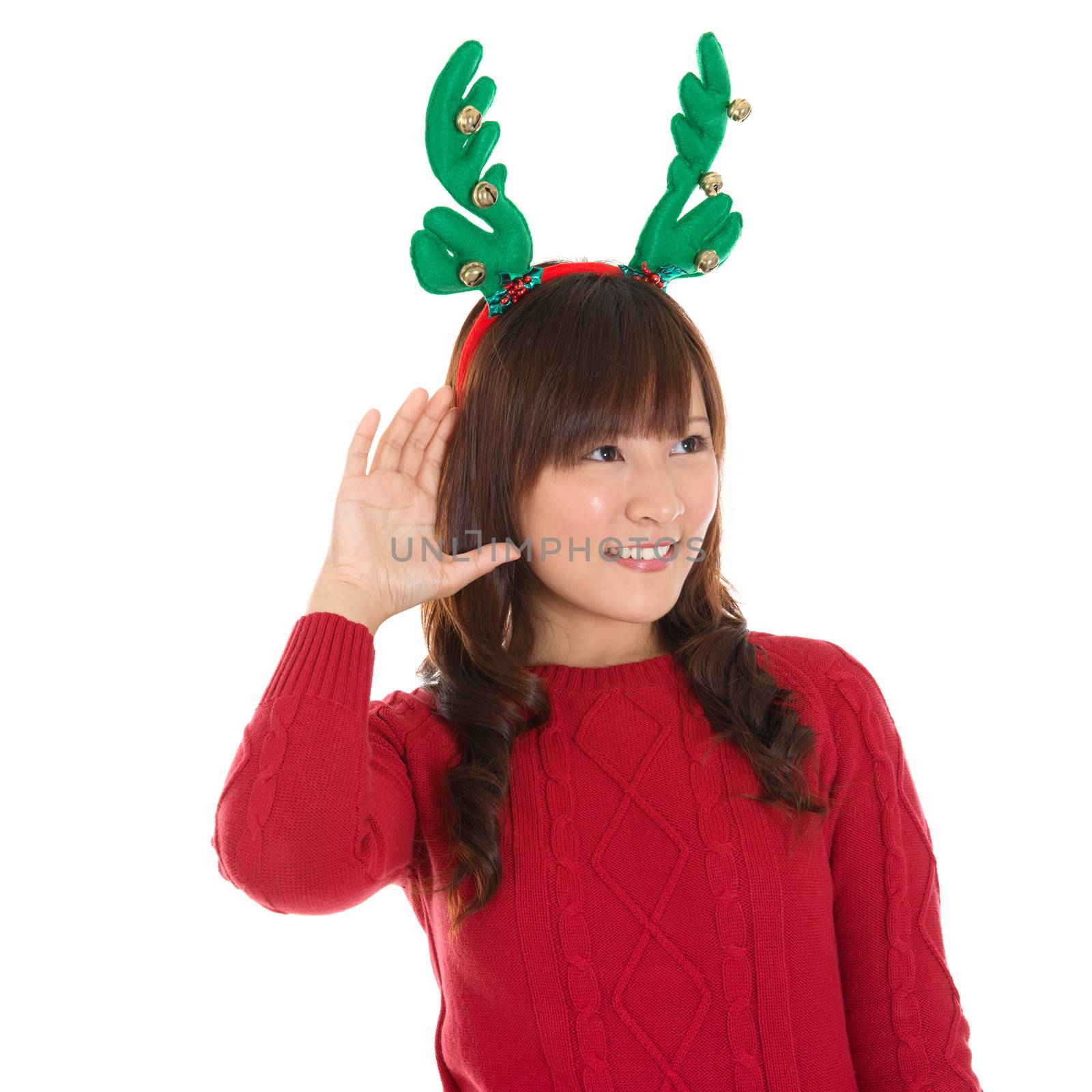 Young Asian Christmas Girl listening isolated on white background, Asian female model.