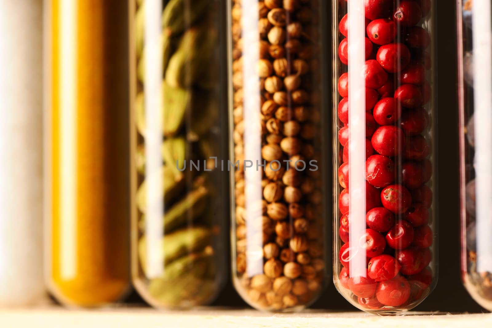 Spices in beakers against dark background