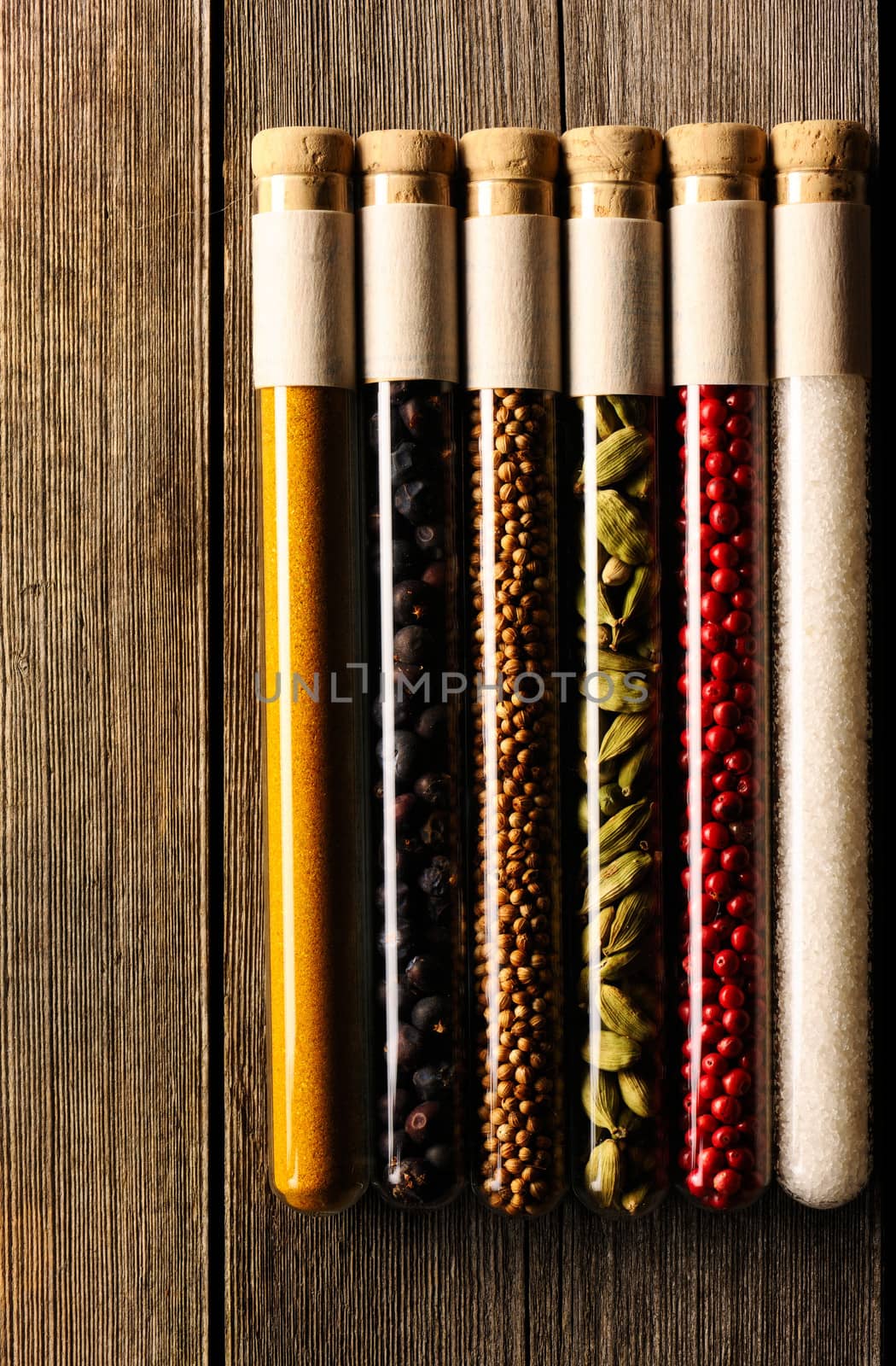 Spices in beakers on wooden background