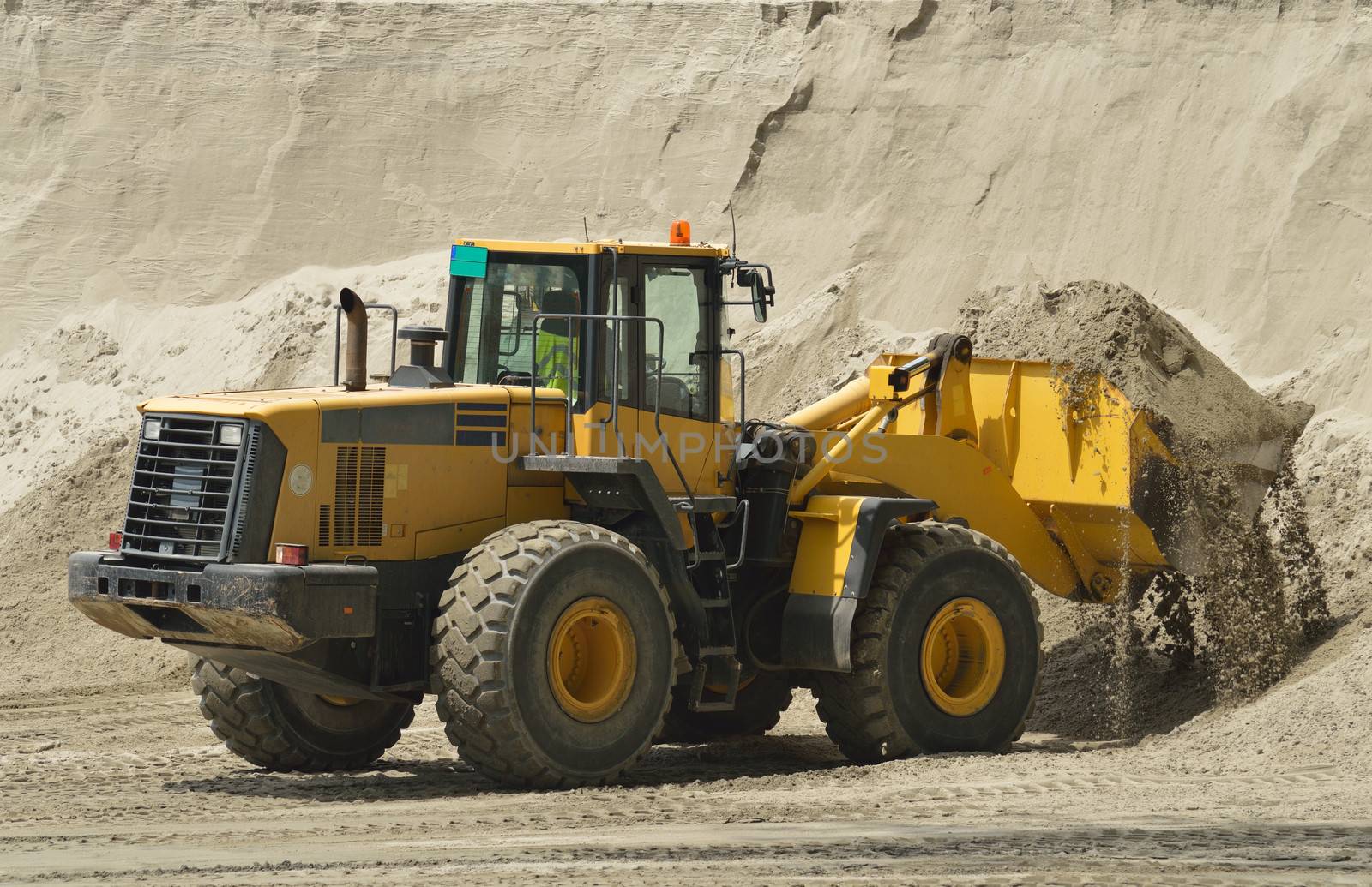 Big yellow bulldozer working on construction site