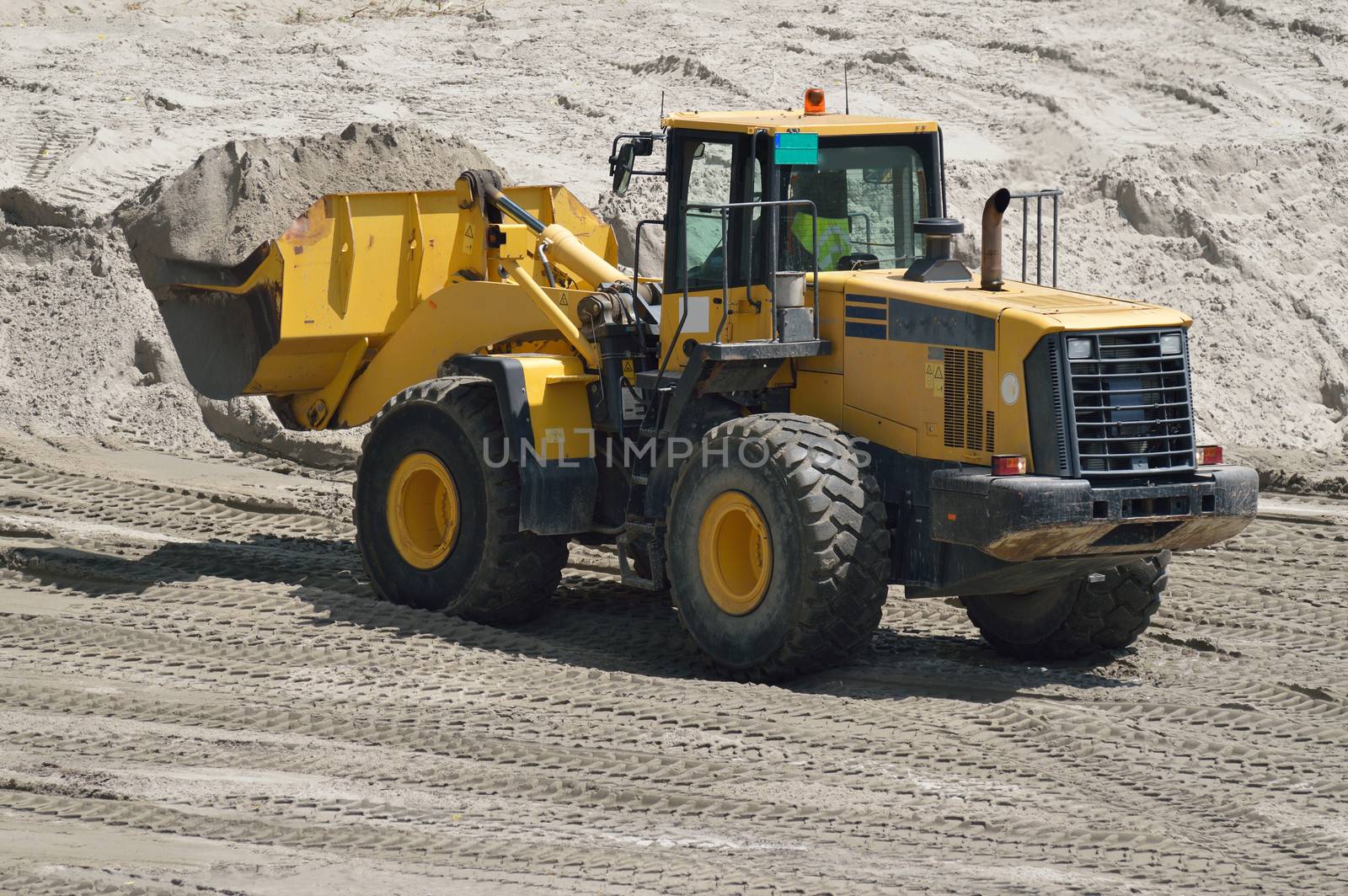 Big yellow bulldozer working on construction site