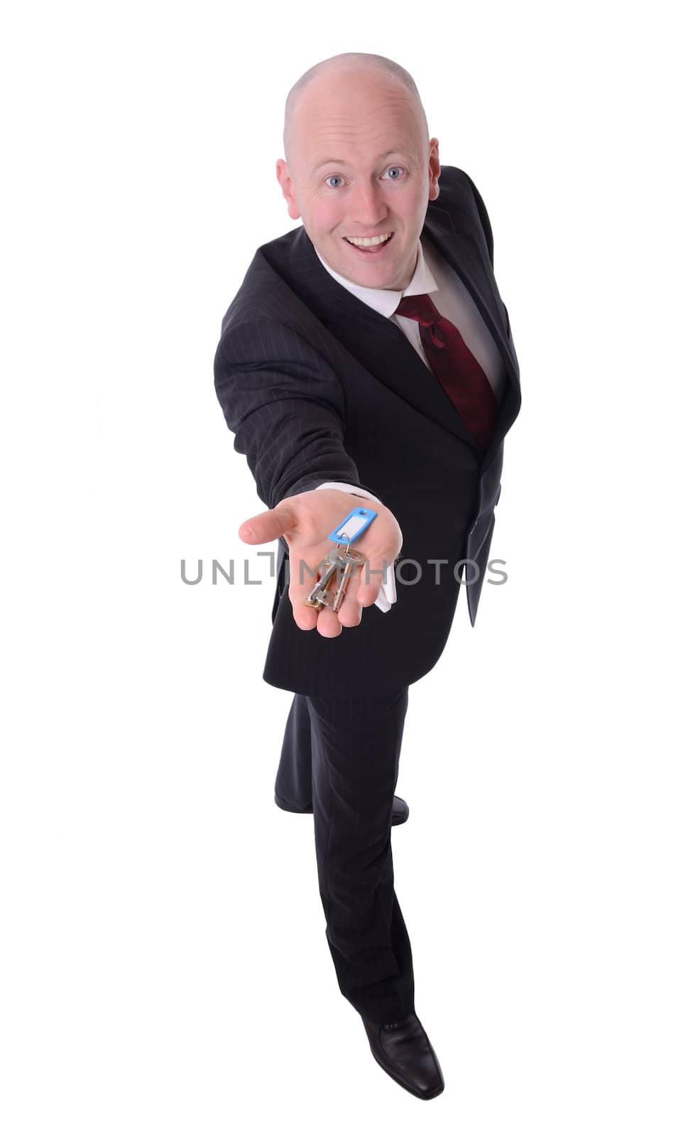 businessman holding out keys isolated on white background