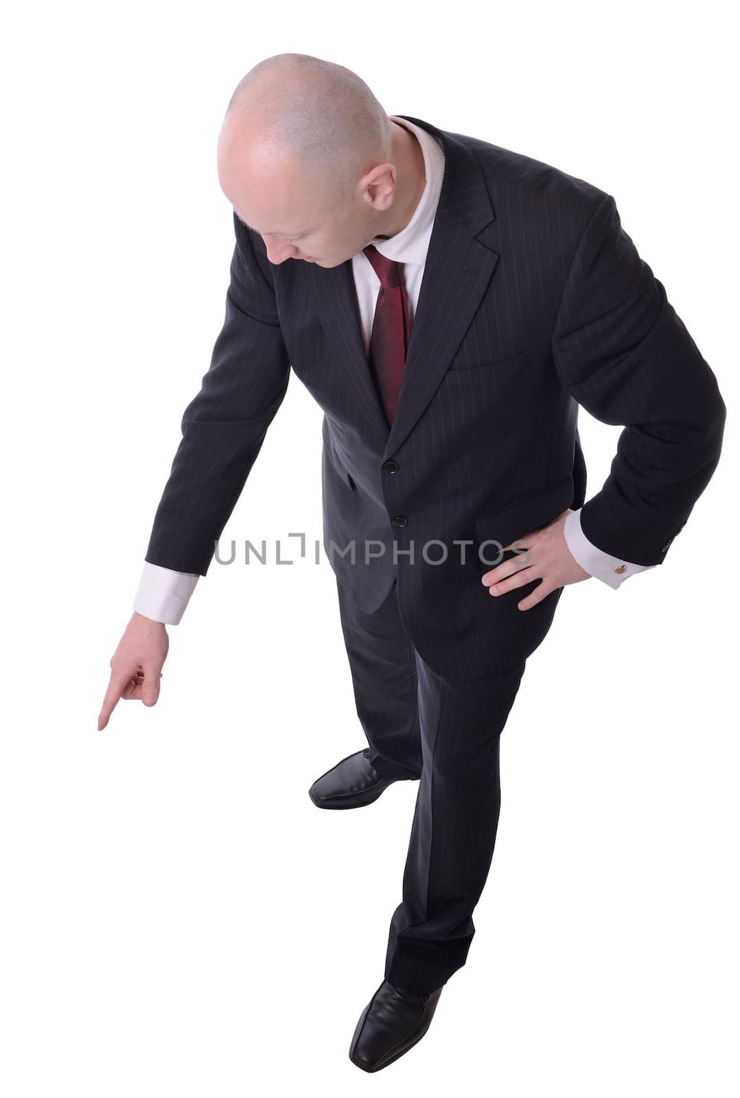 businessman pointing downwards to copy space isolated on white