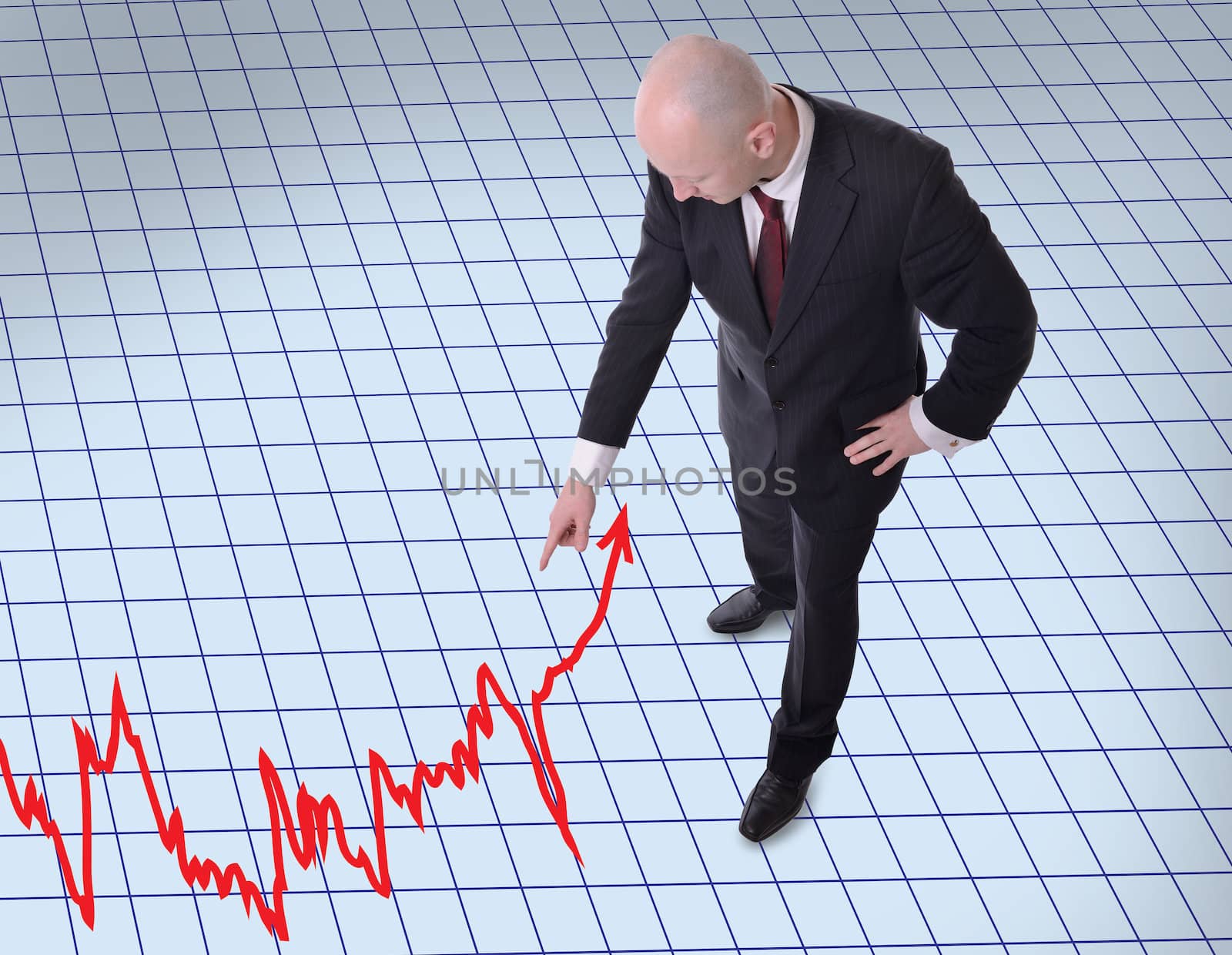 businessman pointing down to graph by hyrons