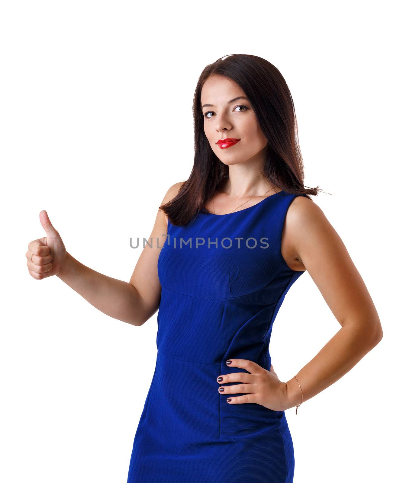 Girl in a dress shows thumb isolated on white background