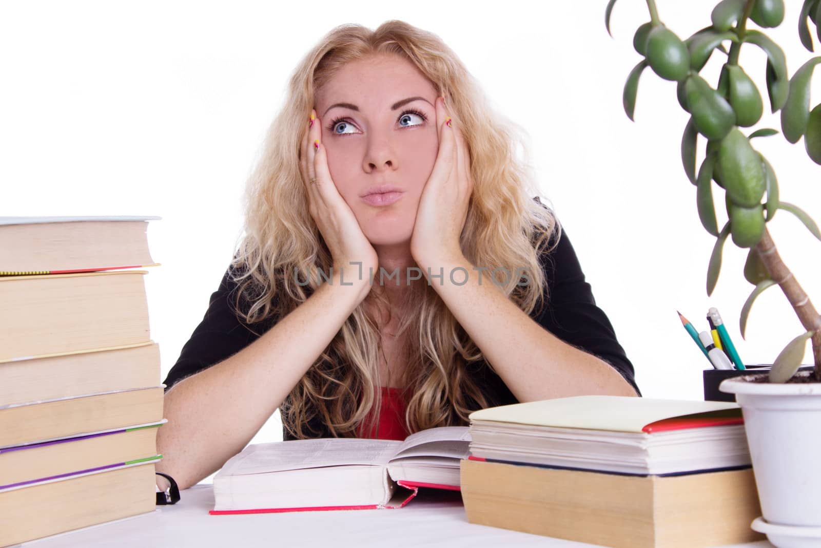 Oveworked student girl with pile of books isolated on white