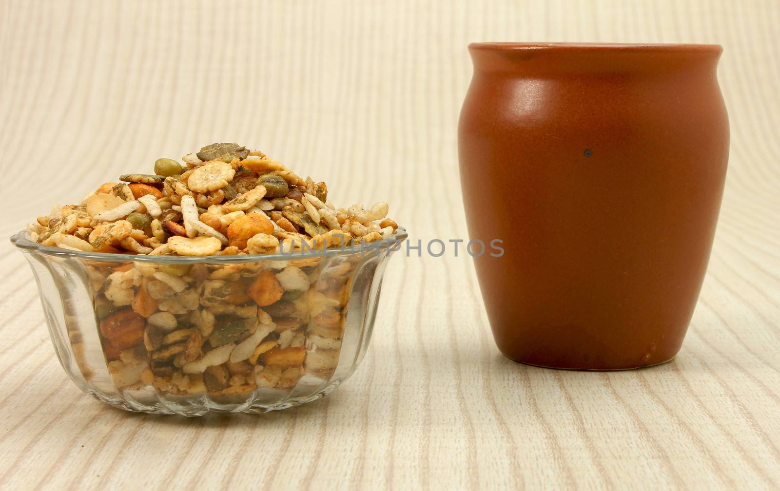namkeen in glass bowl with ceramic cup