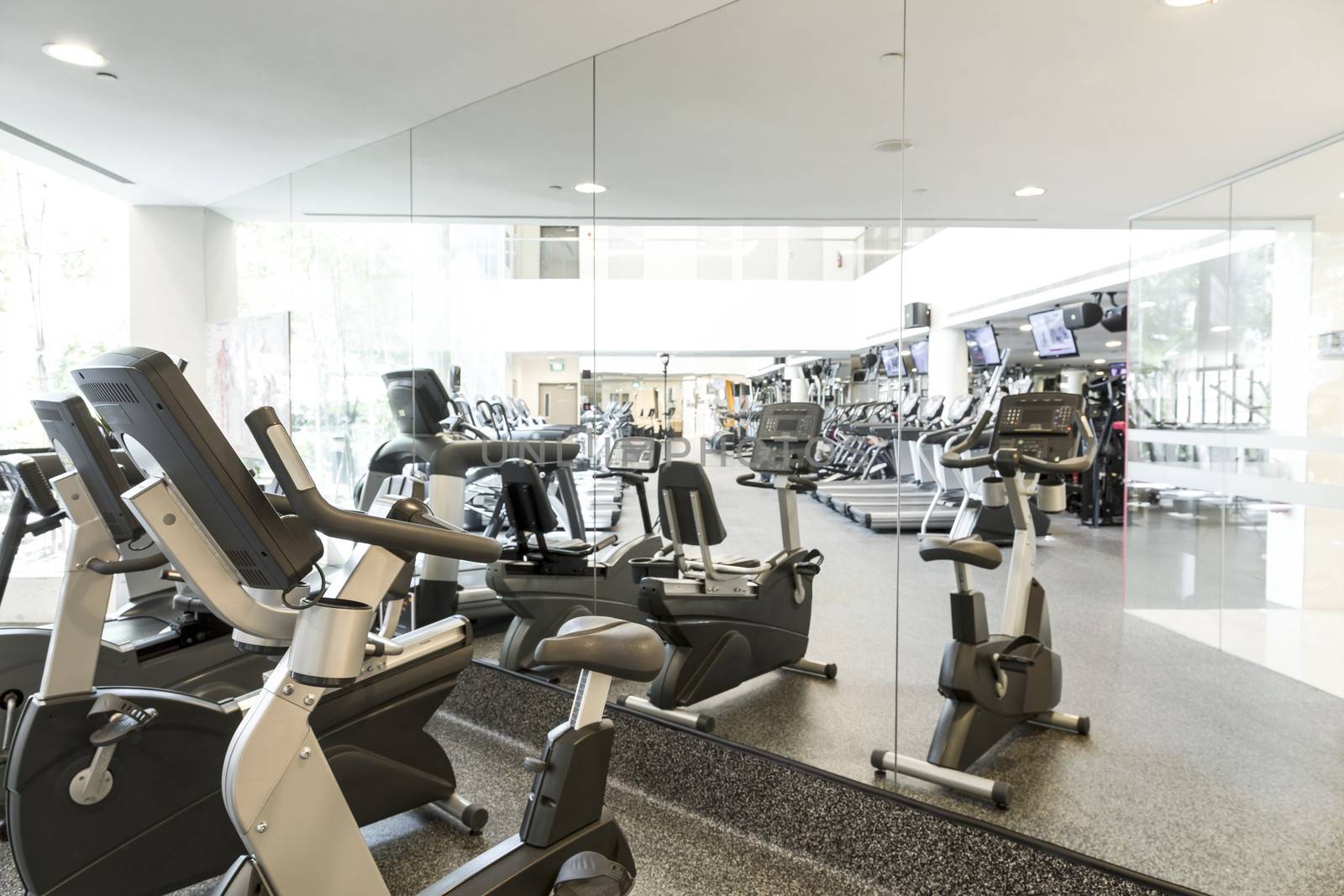An interior shot of a club gym with all the execrise equipments