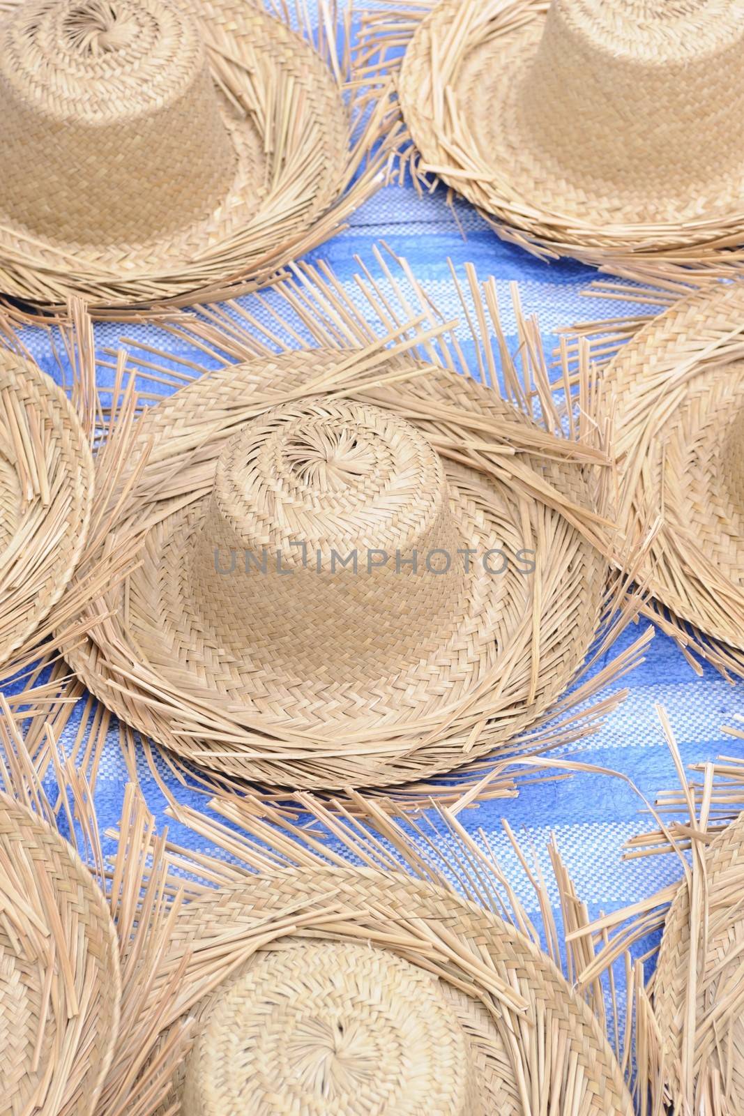 Straw hat in local market. by ngungfoto