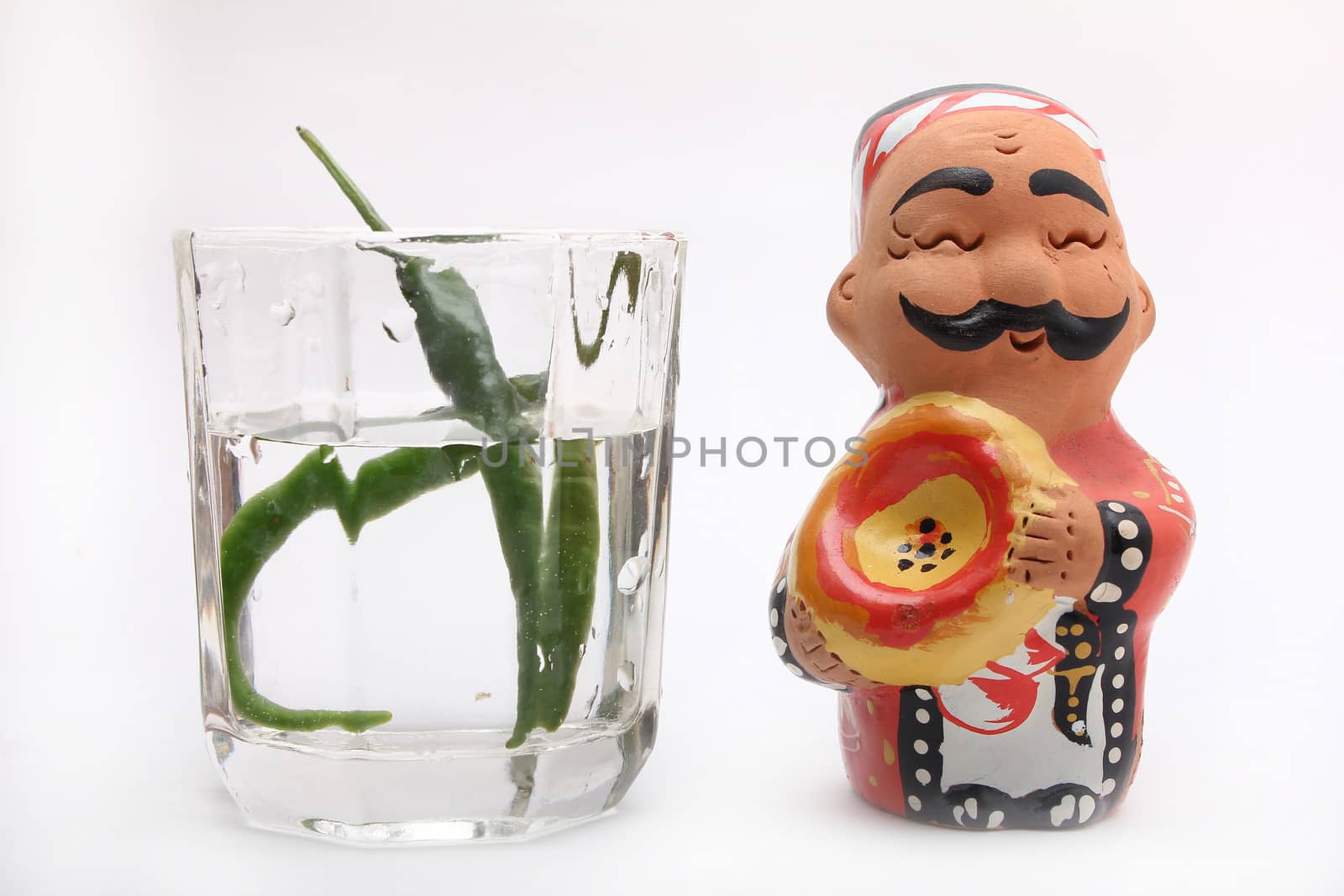 statue with green chilli with water